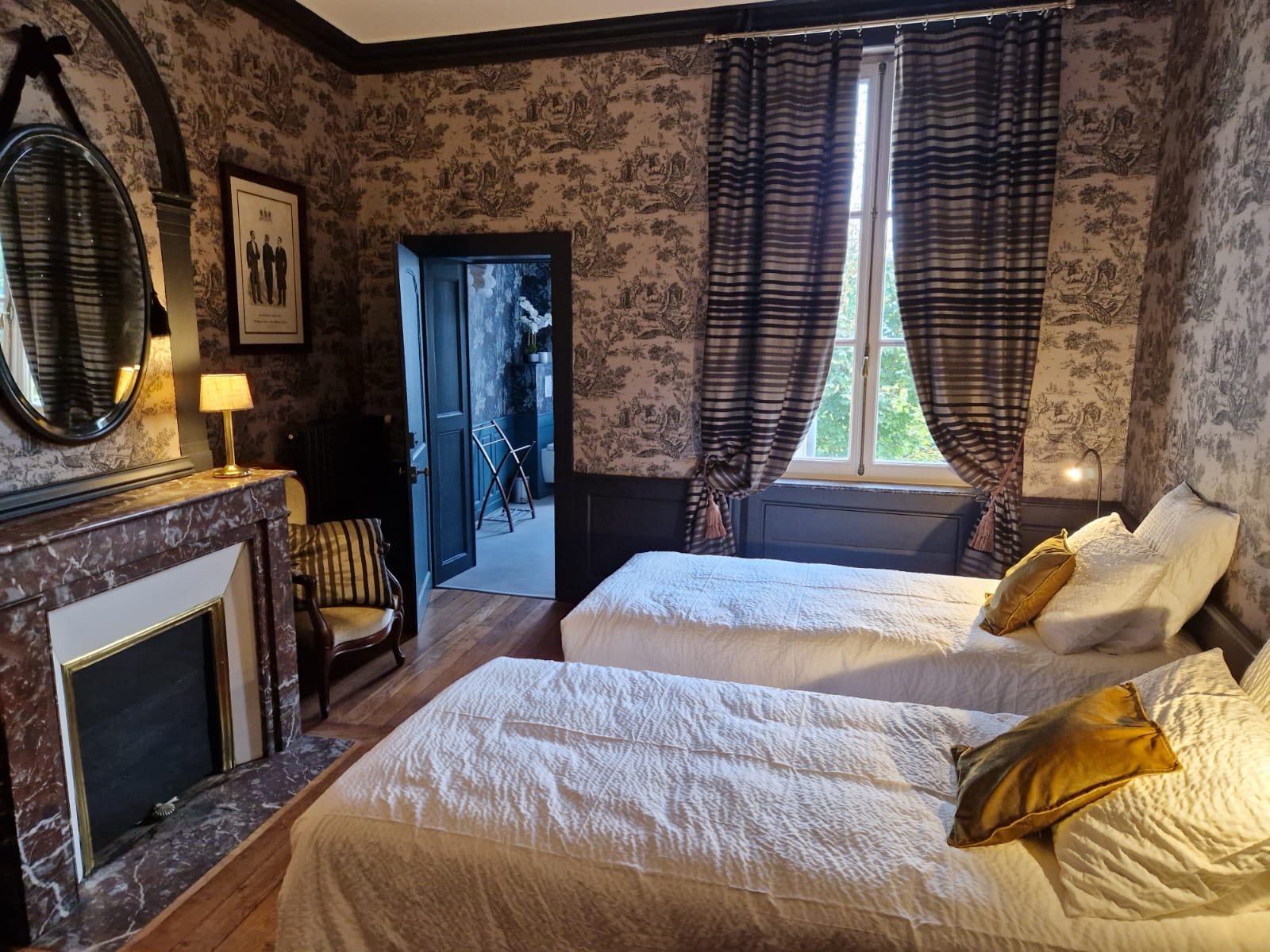 Cheminée de marbre et miroir ovale de la chambre Ernest