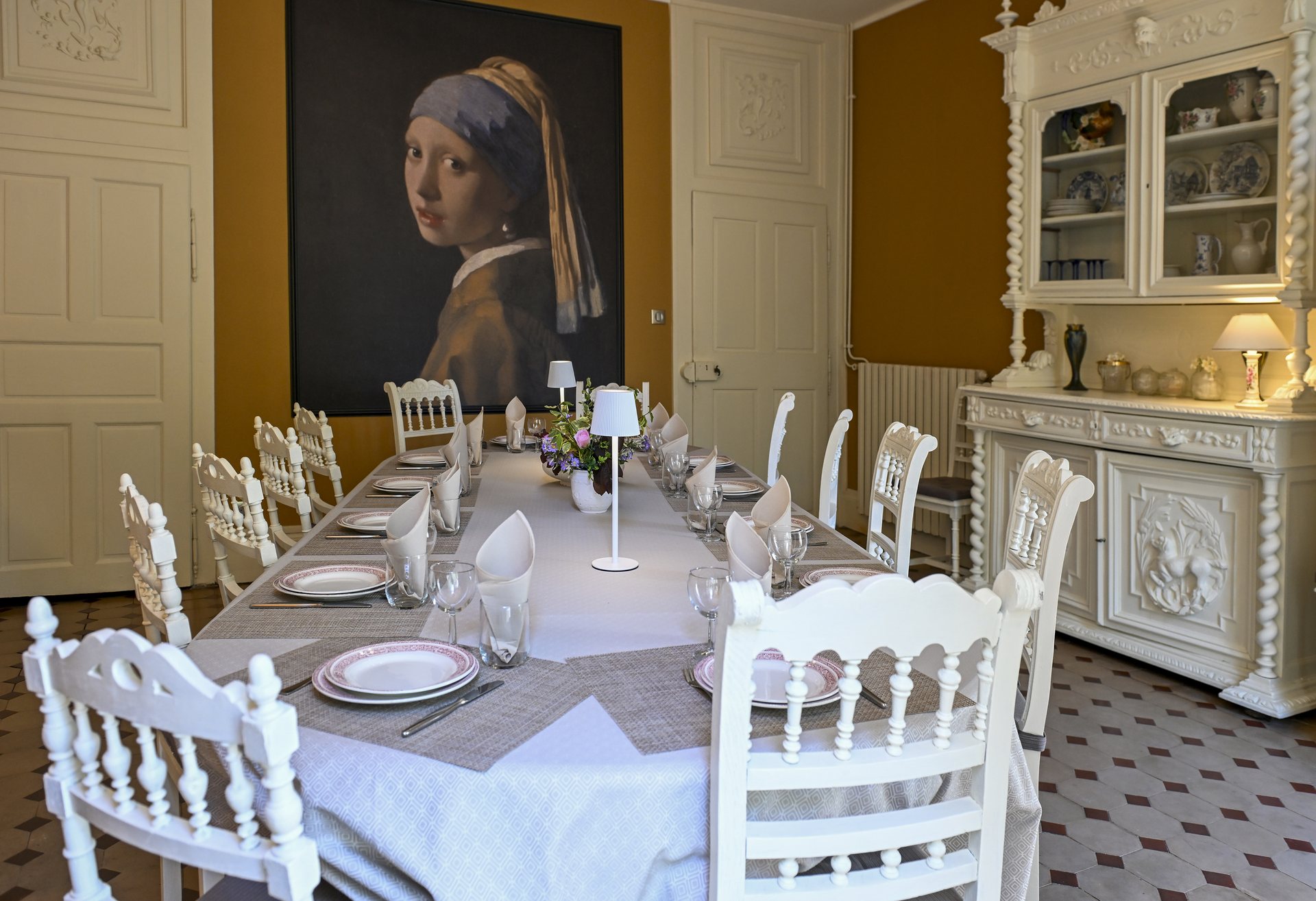 Table dressée de la salle à manger devant la toile de la Jeune Fille à la perle